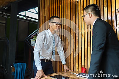 Two businessman expressed a serious expression and fighting by looking into the eye Stock Photo