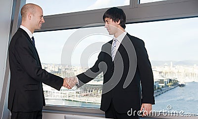 Two businessman making a handshake over a deal Stock Photo