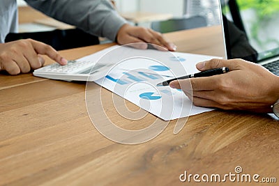 Two businessman working use computer and analysis paper graph mo Stock Photo