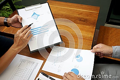 Two businessman working use computer and analysis paper Stock Photo