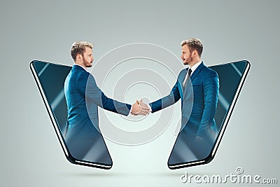 Two businessmen conclude a deal via the Internet. New technologies, modern ways to solve matters. Business and new technologies Stock Photo