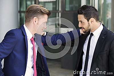 Two businessmen greeting each other outside Stock Photo