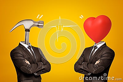 Two businessmen with metal hammer and red heart instead of their heads on yellow background Stock Photo