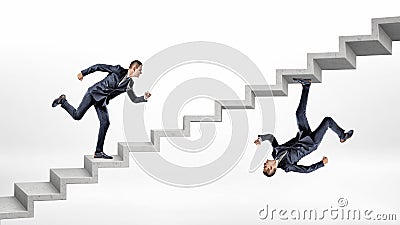 Two businessmen running up concrete stairs in overturned reflected image of each other. Stock Photo