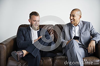 Two businessmen sitting on a couch Stock Photo