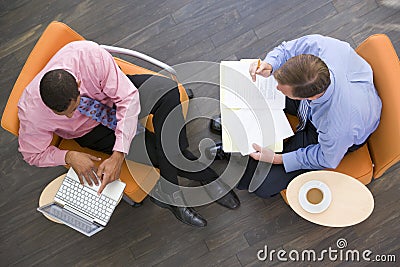 Two businessmen sitting indoors having a meeting Stock Photo