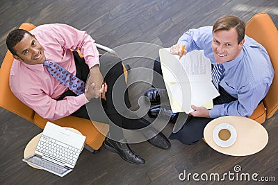 Two businessmen sitting indoors having a meeting Stock Photo