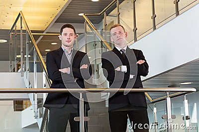 Two businessmen standing with arms crossed Stock Photo