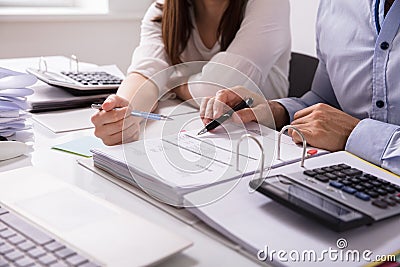 Two Businesspeople Checking Invoice Stock Photo