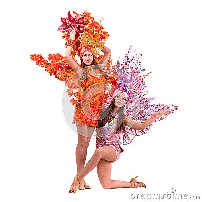 Two carnival dancer women dancing against isolated white Stock Photo