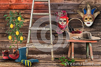 Two carnival masks hanging wall bottom wooden bench wicker b Stock Photo