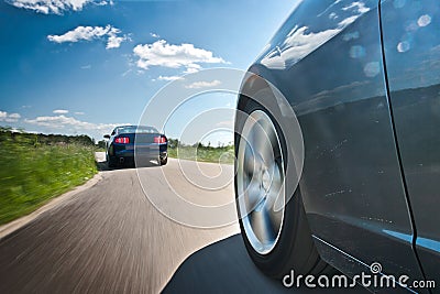 Two cars on the country road Stock Photo
