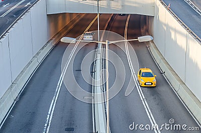 Two cars entering and outing the highway tunnel in morning. Stock Photo