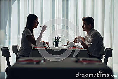 Two casual young adults having a conversation over a meal.Formal proposal,talking in a restaurant.Trying food,offers,special menu Stock Photo