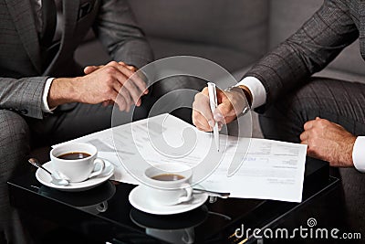 Two caucasian businesspeople sit discussing ideas Stock Photo