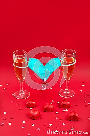 Two champagne glases, candy and medical mask valentine Stock Photo