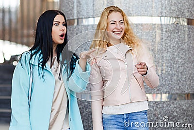 Two cheerful girls near building Stock Photo