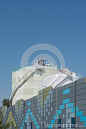 Two chemical tanks in front of colored soundproof wall Stock Photo