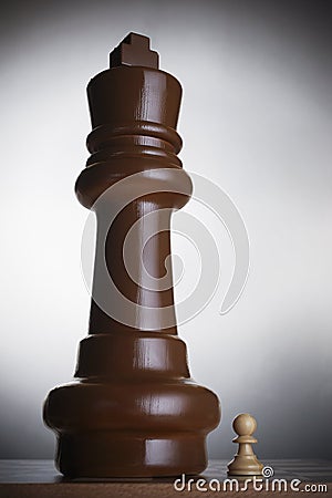 Two chess pieces large king and small pawn Stock Photo
