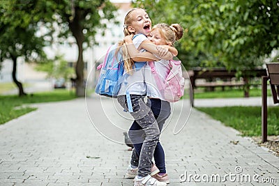 Two children hug and laugh. The concept of school, study, education, friendship, childhood. Stock Photo
