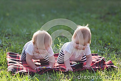 Two children of 6 months crawl a blanket Stock Photo