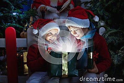 Two children opening Christmas gift Stock Photo