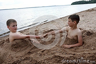 Two children play on sandy beach of Lake Seliger Stock Photo