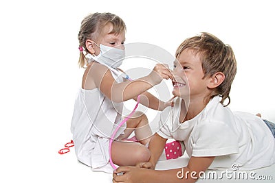 Two children playing as doctor and patient Stock Photo