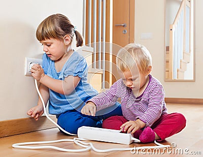 Two children playing with electricity Stock Photo