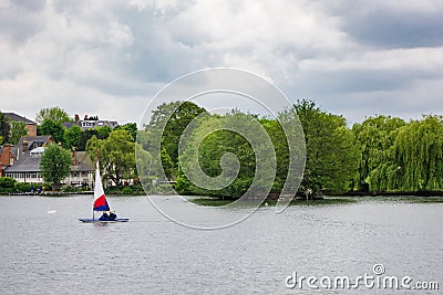 Two children practice sailing on a Spring day in South Norwood l Stock Photo