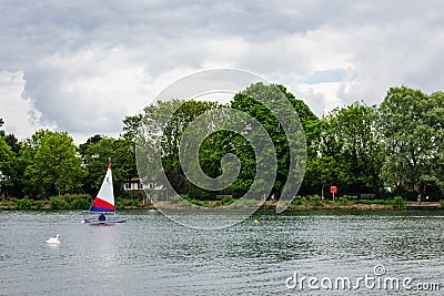 Two children practice sailing on a Spring day in South Norwood l Stock Photo