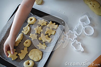 Two children put cookies on a baking sheet. homemade desserts. The view from the top Stock Photo