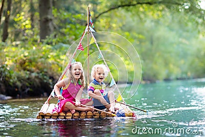 Kids on wooden raft Stock Photo
