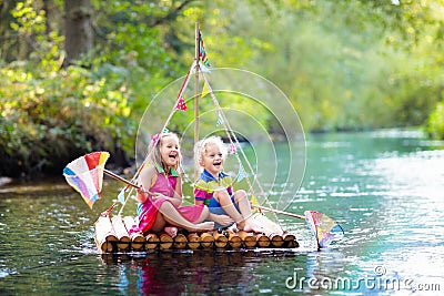 Kids on wooden raft Stock Photo