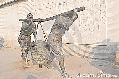 Chinese bronze sculpture art two people pick the pole Editorial Stock Photo