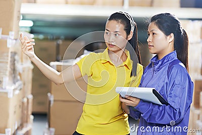 Two chinese female workers in warehouse Stock Photo