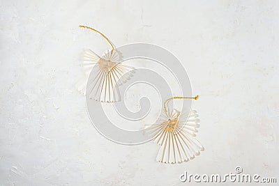 Two Christmas paper angels on white textured background. Top view, flat lay Stock Photo