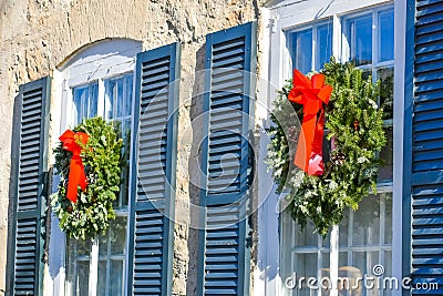 Christmas Wreaths Hanging on Windows Stock Photo