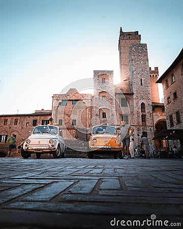 Two Classic Fiat 500 in San Gimignano`s main square Editorial Stock Photo