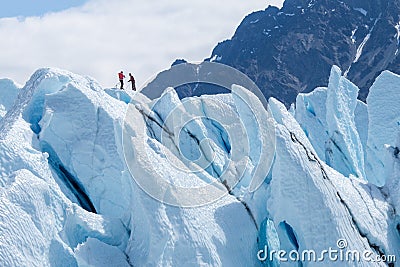 Two climbers reached the top of iceberg Stock Photo