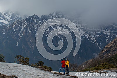 Two climbers standing near the huge mountain Editorial Stock Photo