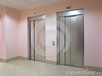 Two closed elevators in a business lobby Stock Photo