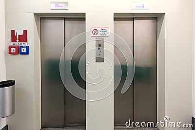 Two closed metal elevator doors in underground parking Stock Photo