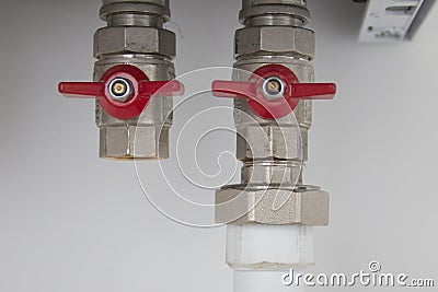 Two closed valves of the tap of the water supply system Stock Photo