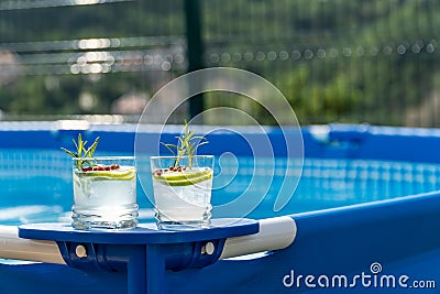 Two cocktails on a portable swimming pool Stock Photo