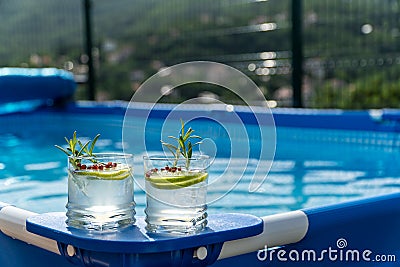 Two cocktails on a portable swimming pool Stock Photo