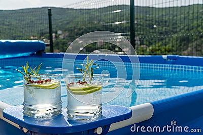 Two cocktails on a portable swimming pool Stock Photo