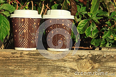 Two coffees to go on the wooden balcony. Lifestyle concept Stock Photo