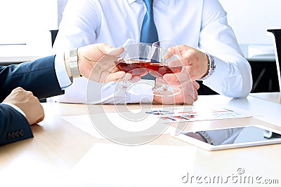 Two colleagues celebrate signing a contract with Whisky Stock Photo