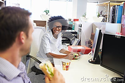 Two colleagues having a lunch break at work Stock Photo